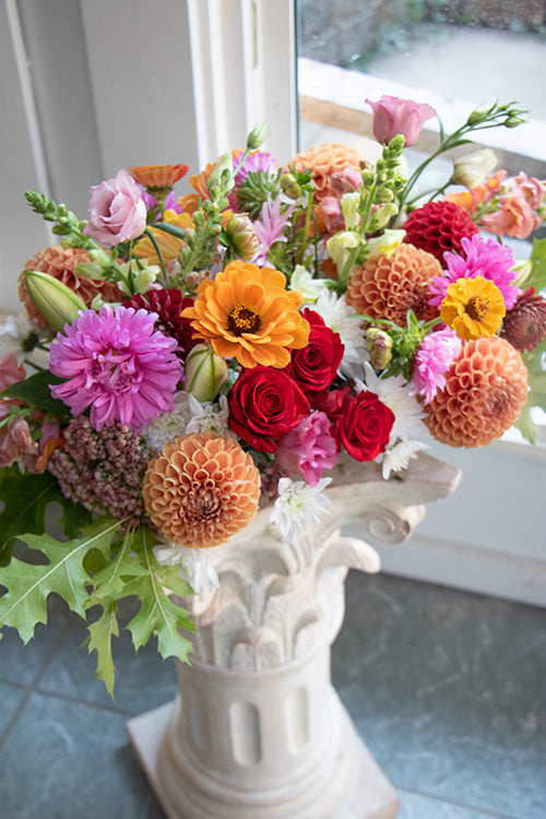 Dining table centrepiece of seasonal flowers